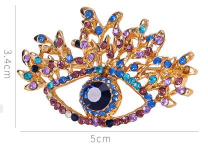 Spilla: occhio scaramantico modello diamante colorato. Portafortuna!